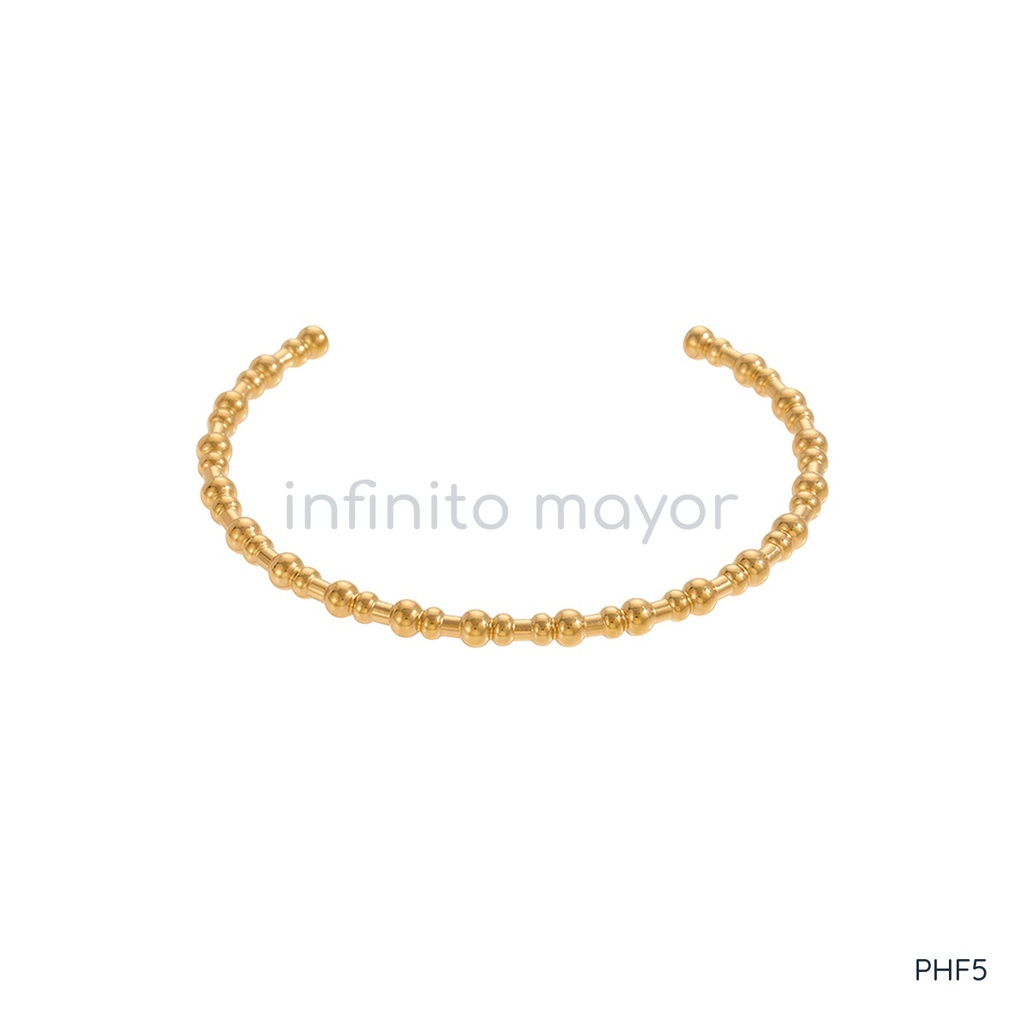 Pulsera dorada fina y abierta, diseño de brazalete de bolitas y segmentos cortos alternados con acabado brillante