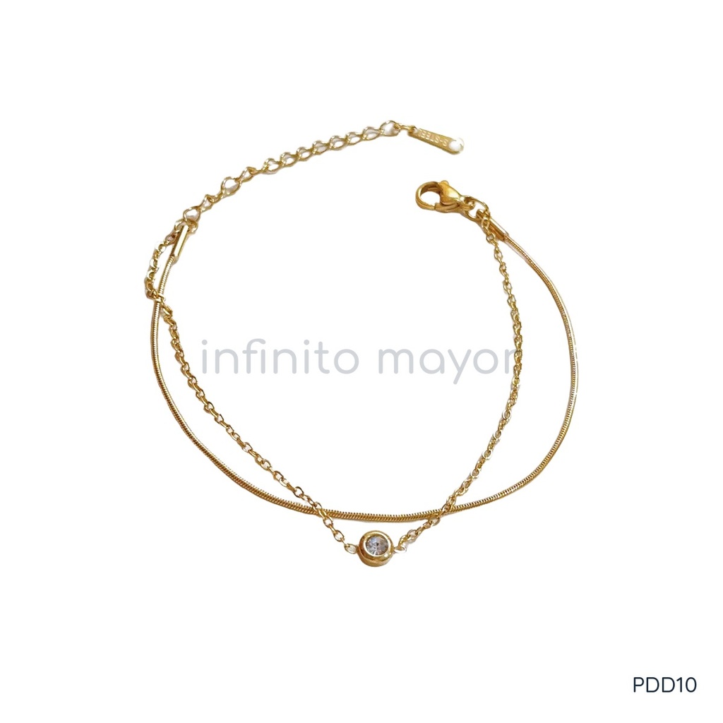 Pulsera dorada, doble cadena con una circonia solitaria