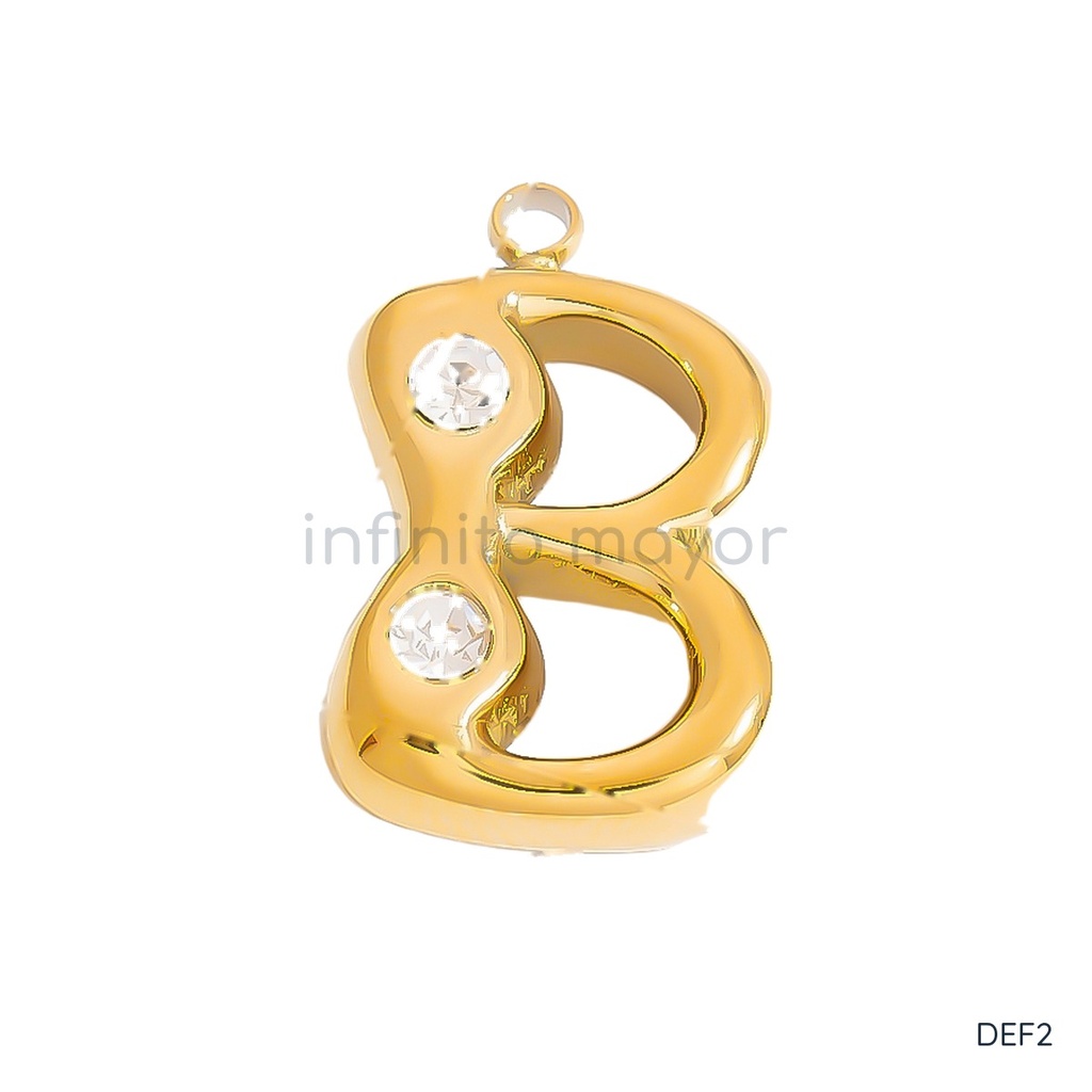 Dije dorado en forma de letra B de trazo abombado y liso, con circonias transparentes en los extremos y argolla superior